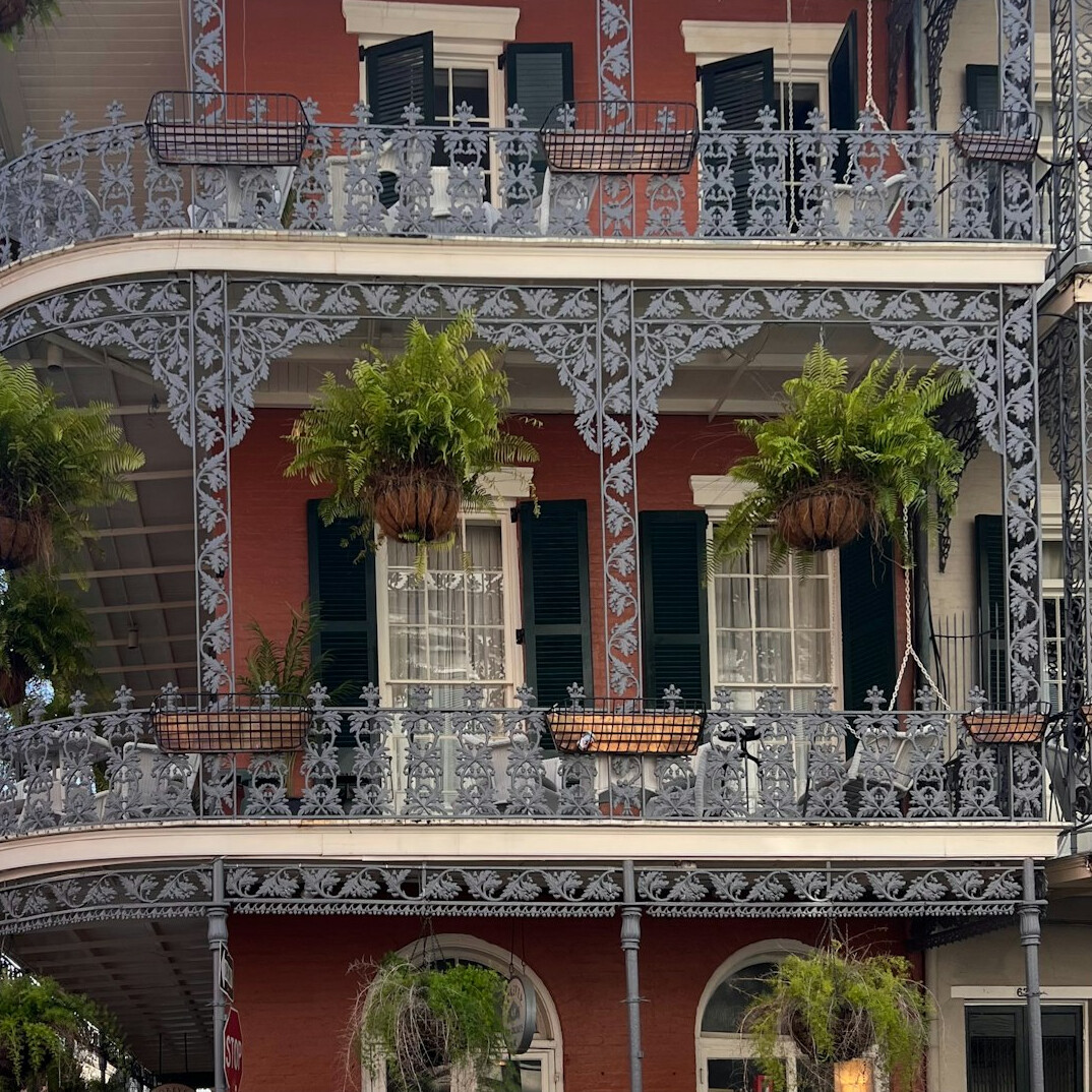 Historic colonial building facade with wrought iron balconies