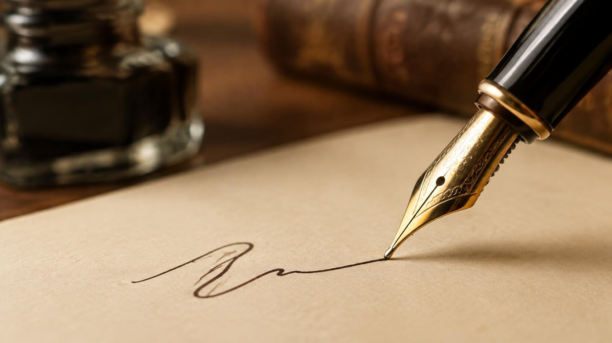 Close up of an antique fountain pen writing on paper